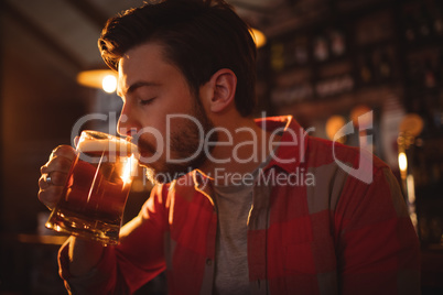 Young man having mug of beer