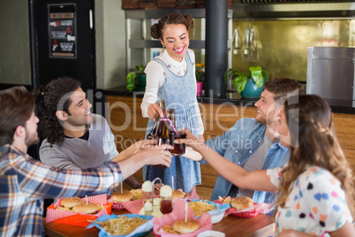 Group of friends spending leisure time in restaurant