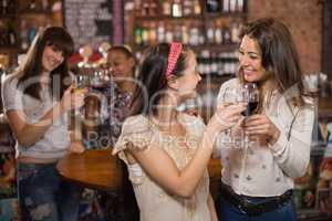 Happy female friends toasting wineglasses
