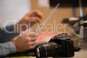 Camera on desk by photographer in creative office