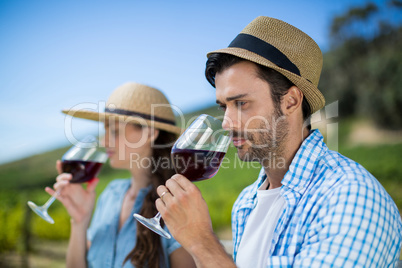 Thoughtful man smelling red wine in glass