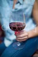 Woman holding red wine glass