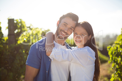 Portrait of young couple embracing at vineyard