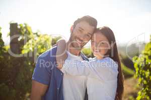 Portrait of young couple embracing at vineyard
