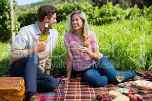 Happy couple holding winebottle and glass