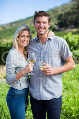 Portrait of young couple holding wineglasses