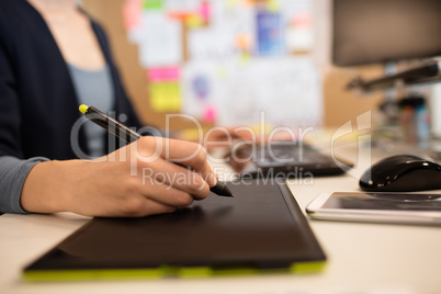 Close up of businesswoman working on graphics tablet