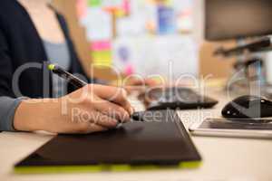 Close up of businesswoman working on graphics tablet