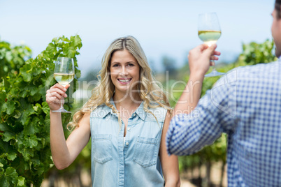 Happy woman with man holding wineglass