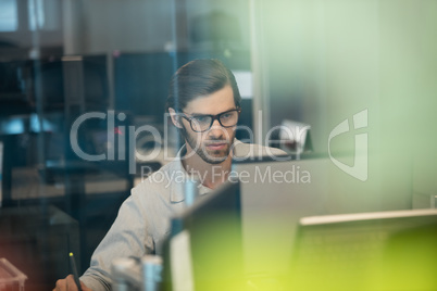 Concentrated businessman working on computer at office
