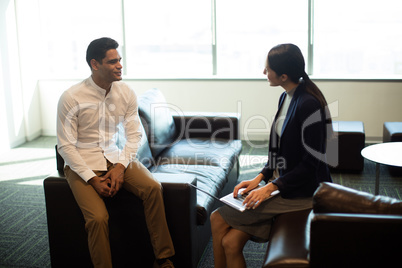 Businessman ineracting with female colleague in office