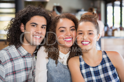 Smiling friends sitting at restaurant