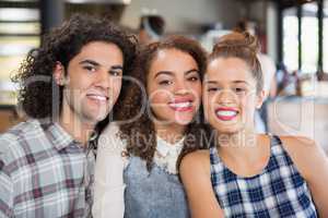 Smiling friends sitting at restaurant