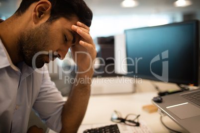 Worried businessman sitting in office