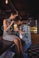 Happy couple having milkshake