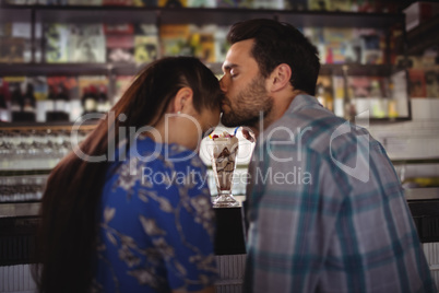 Affectionate man kissing woman at counter