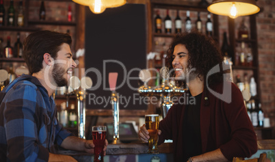 Friends having beer at bar counter