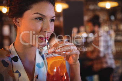 Young woman having cocktail drink