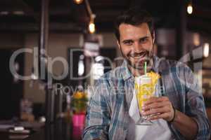 Portrait of happy man having milkshake