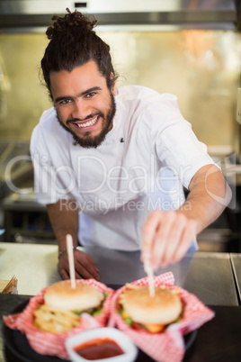 Male chef preparing burger in commercial kitchen