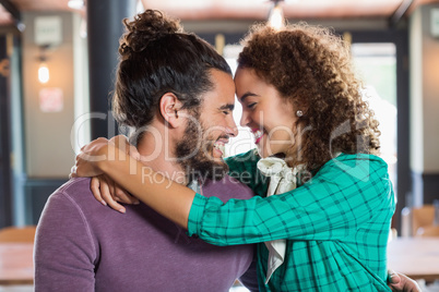 Young couple embracing in restaurant