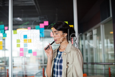 Female executive smoking electronic cigarette