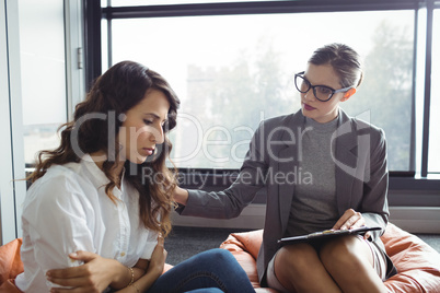 Counselor consoling unhappy woman