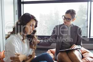 Counselor consoling unhappy woman