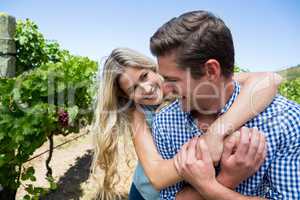 Happy couple embracing at vineyard