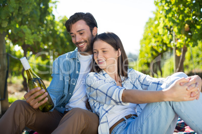 Happy couple holding wine bottle