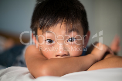 Boy looking at camera in bedroom