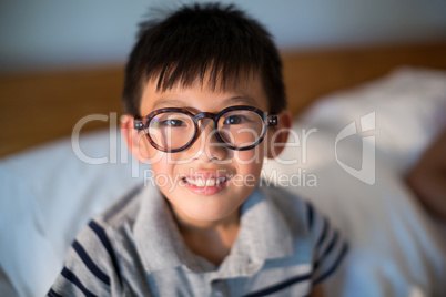 Boy in spectacles looking at camera