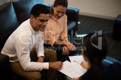 High angle view of businessman discussing with female colleagues
