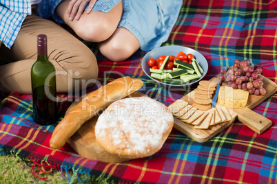 High angle view of wine bottle and food by couple