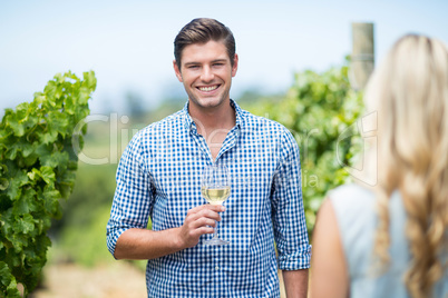 Portrait of young man holding wineglass