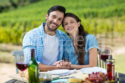 Portrait of happy couple sitting at table