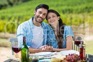 Portrait of happy couple sitting at table