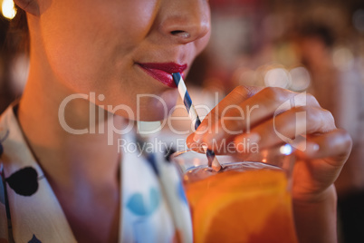 Close-up of woman having cocktail drink