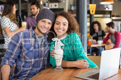 Portrait of smiling couple sitting in restaurant