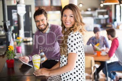 Portrait of smiling woman sitting in restaurant