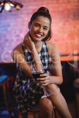Portrait of young woman having red wine