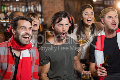 Cheerful friends shouting in pub