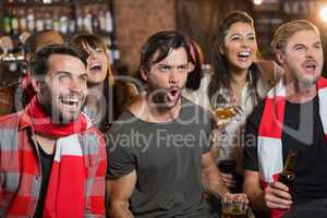 Cheerful friends shouting in pub