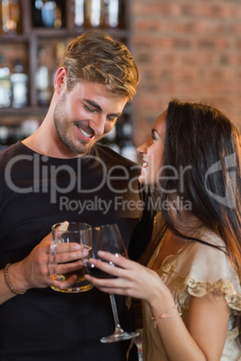 Happy young couple holding drink glasses