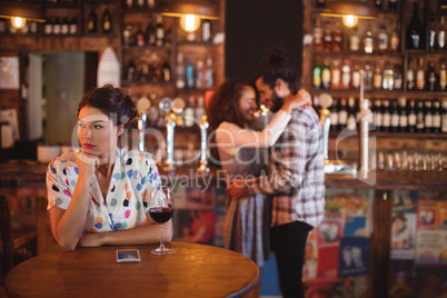 Jealous woman ignoring affectionate couple