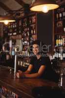 Male bar tender at bar counter