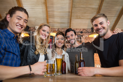 Portrait of happy friends with beer glass and bottles