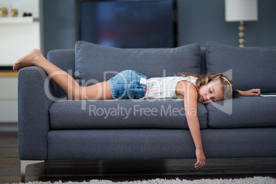 Girl sleeping on sofa in living room