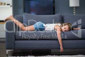 Girl sleeping on sofa in living room