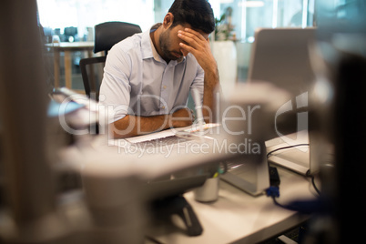 Worried businessman sitting in office